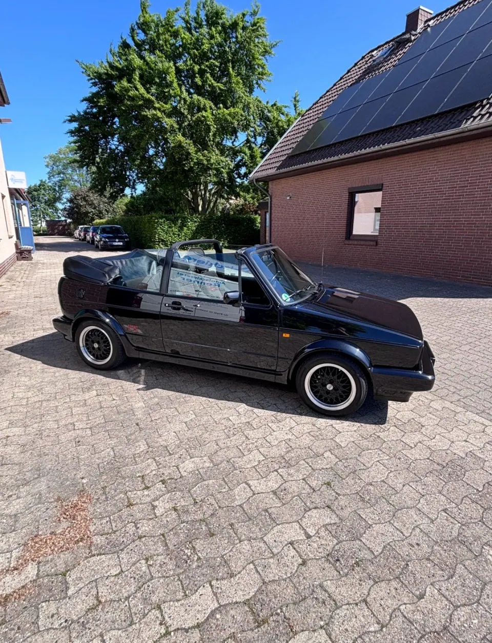 Schwarzes VW Golf Cabrio mit Hochglanzlack und BBS-Felgen vor der Werkstatt